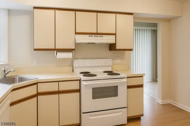 a kitchen with white cabinets and white appliances
