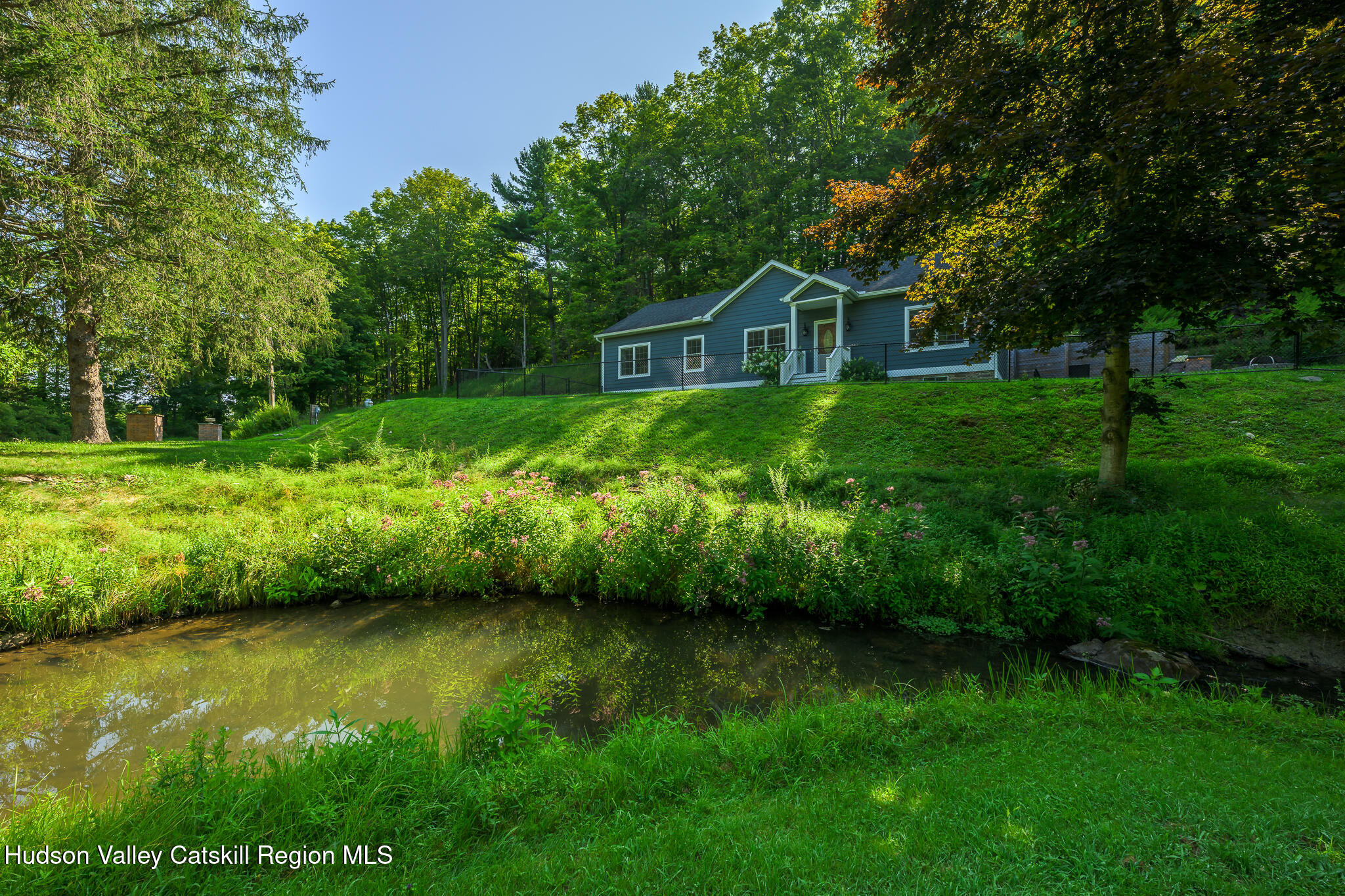 218 Decker Road Craryville, NY 12521 - Photo 20 of 21 a view of a garden with a bench