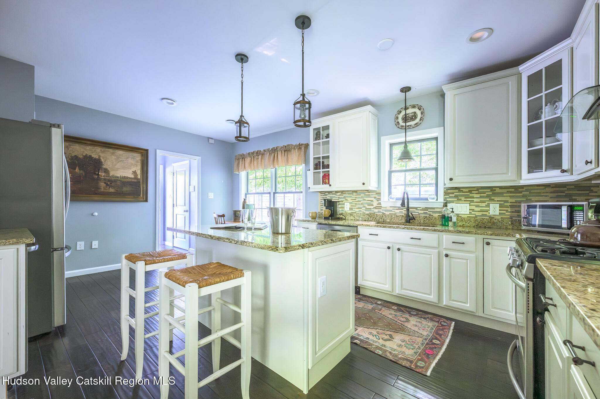 218 Decker Road Craryville, NY 12521 - Photo 4 of 21 a open kitchen with granite countertop a stove a sink dishwasher a dining table and chairs with wooden floor