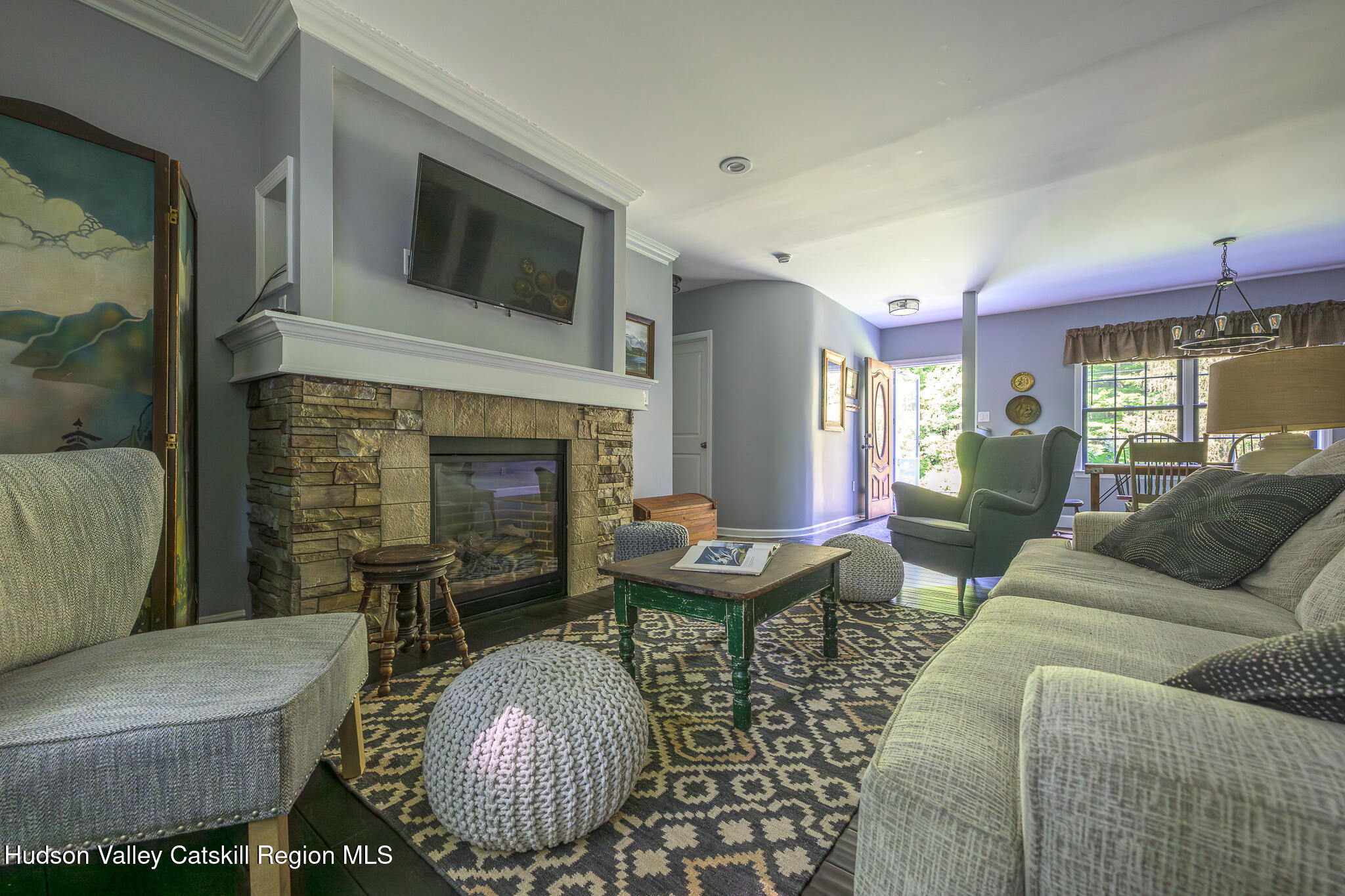 218 Decker Road Craryville, NY 12521 - Photo 5 of 21 a living room with furniture a fireplace and a flat screen tv