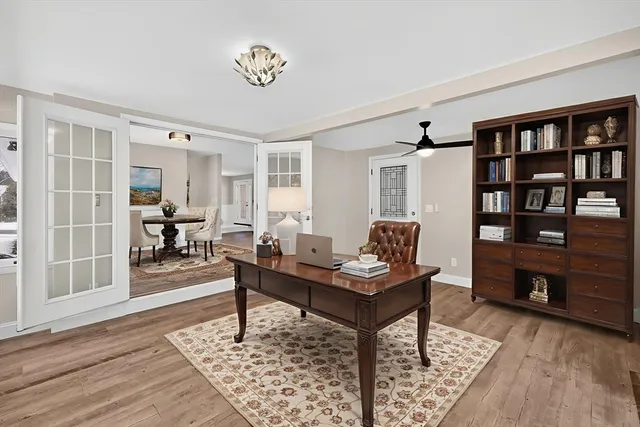 a living room with furniture and a book shelf
