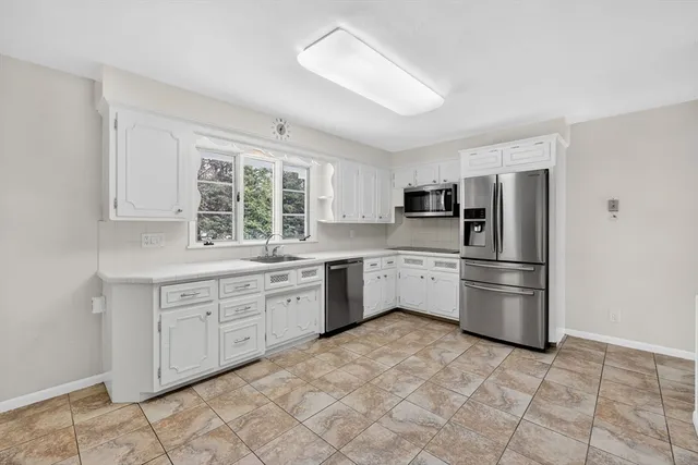 a kitchen with a sink appliances and cabinets