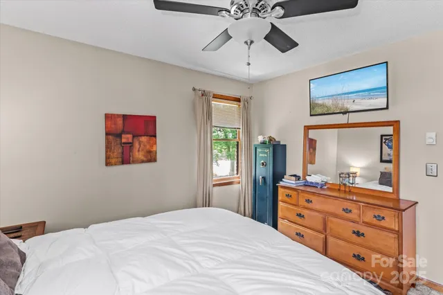 a bedroom with a bed and a dresser