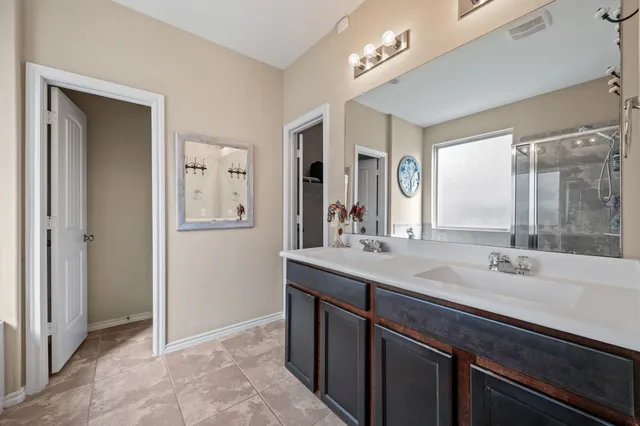 a bathroom with a sink double vanity and a mirror