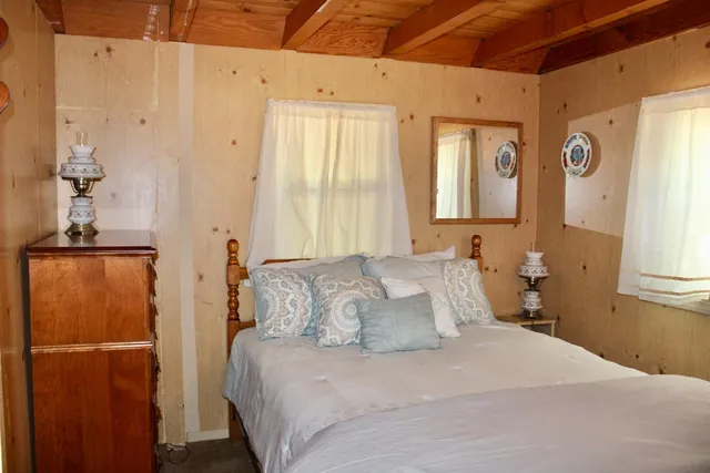 a bedroom with a bed and a mirror