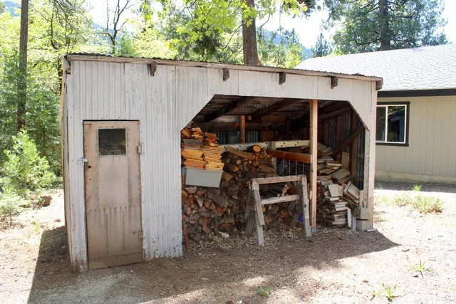 a view of a house with a bed and chair under an umbrella