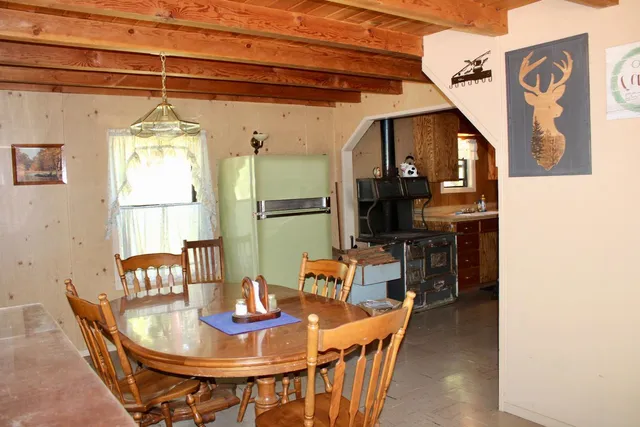 a dining room with furniture and window