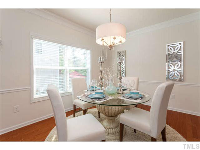 Great size dining space with crown molding and chair railing.