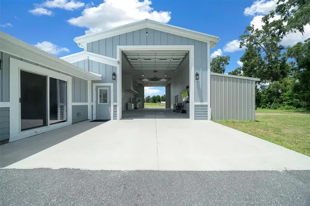 an empty room with fireplace and stairs