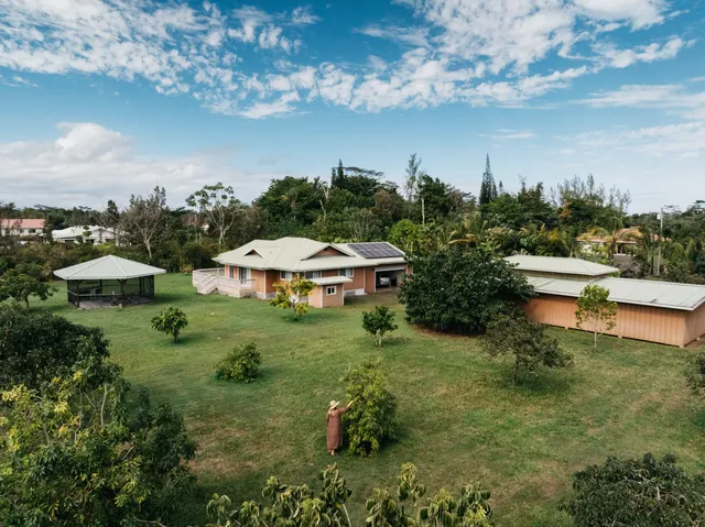 an aerial view of a house with yard swimming pool and outdoor seating