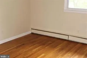 a view of a room with wooden floor