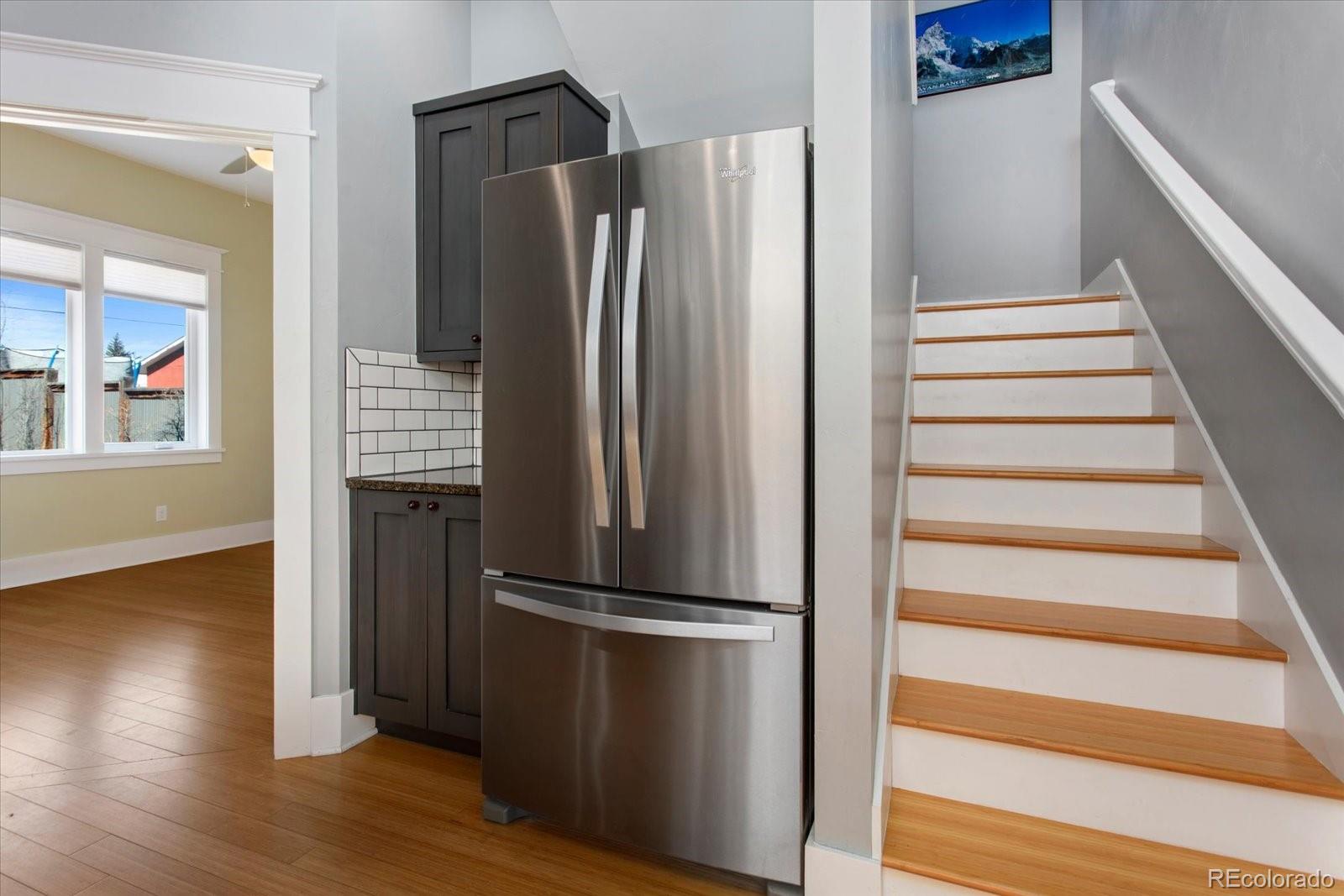1208 E Street Salida, CO 81201 - Photo 16 of 50 a view of a kitchen with wooden floor and a refrigerator
