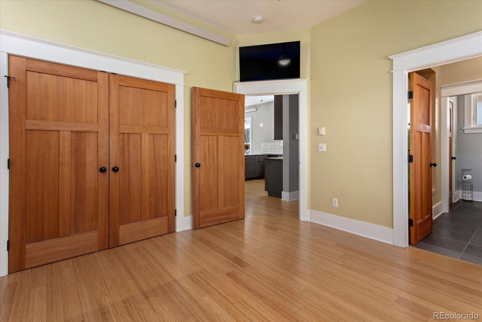 1208 E Street Salida, CO 81201 - Photo 18 of 50 wooden floor in an empty room with a window