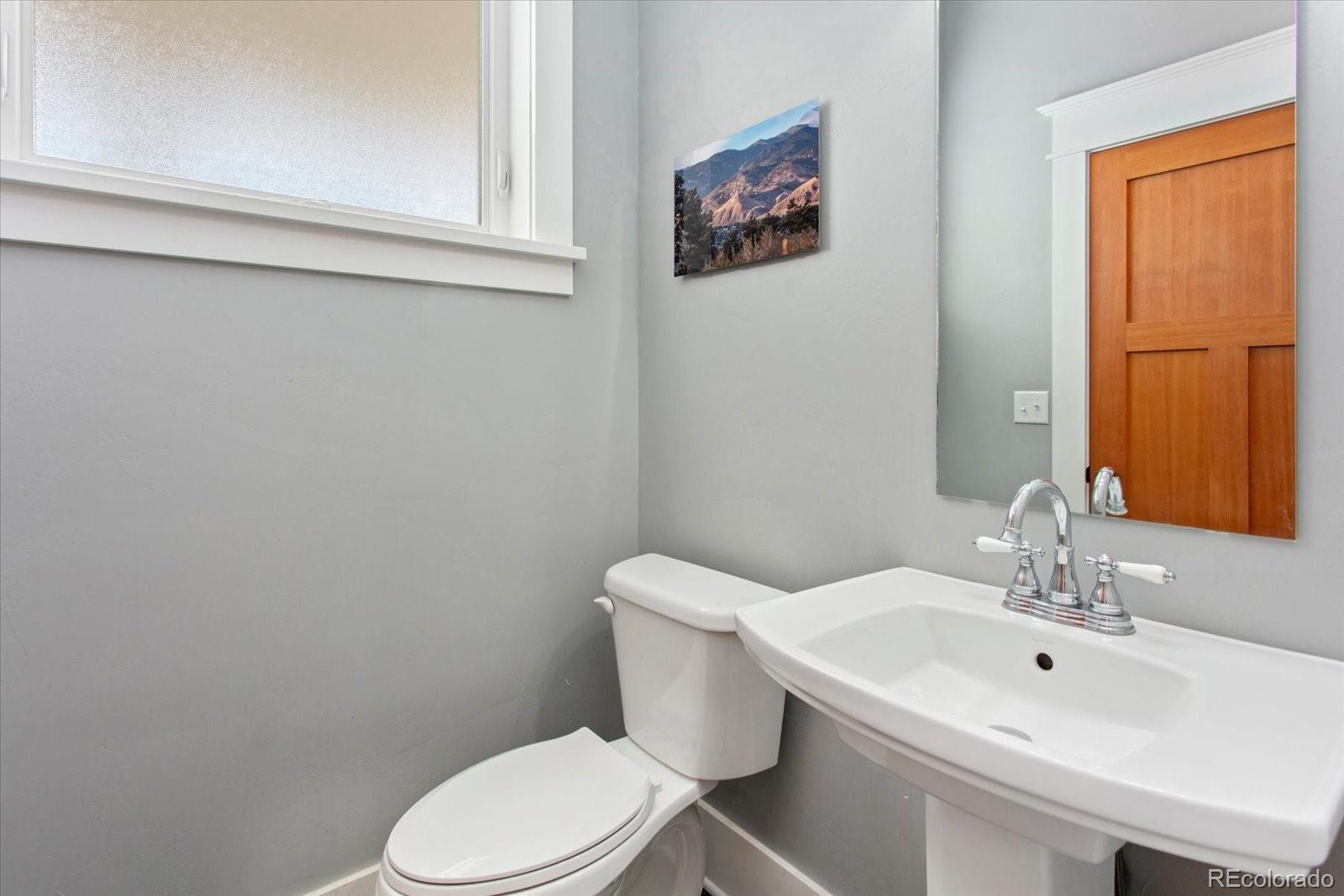 1208 E Street Salida, CO 81201 - Photo 20 of 50 a bathroom with a sink mirror and toilet