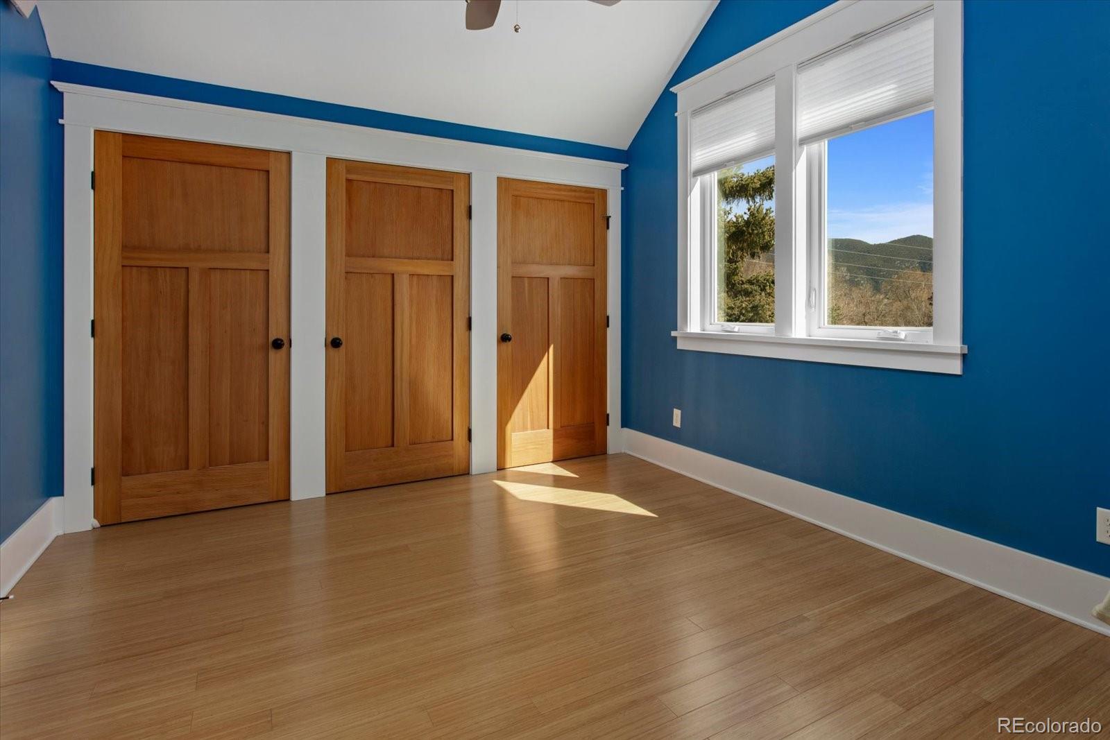 1208 E Street Salida, CO 81201 - Photo 24 of 50 a view of an empty room with wooden floor and a window