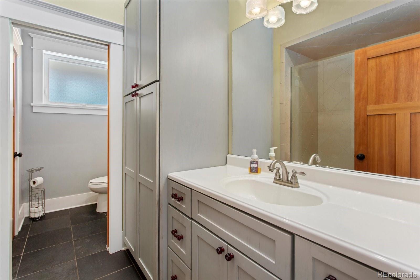 1208 E Street Salida, CO 81201 - Photo 28 of 50 a bathroom with a sink a toilet and a mirror