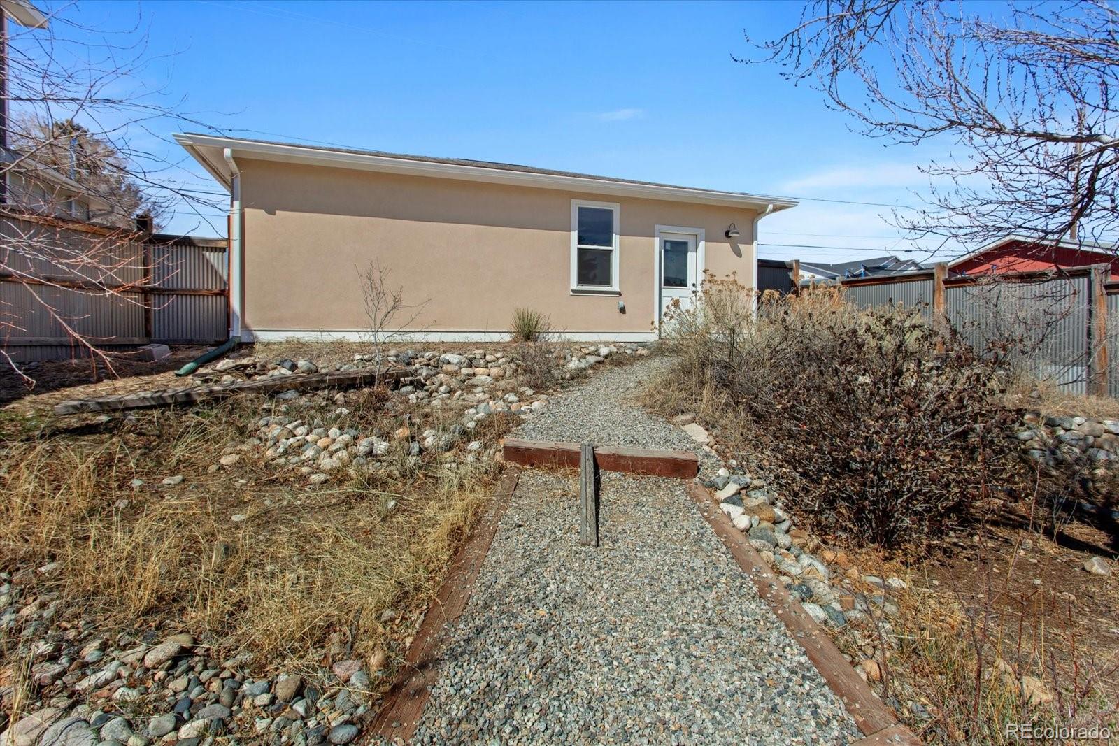 1208 E Street Salida, CO 81201 - Photo 40 of 50 a backyard of a house with large trees and wooden fence