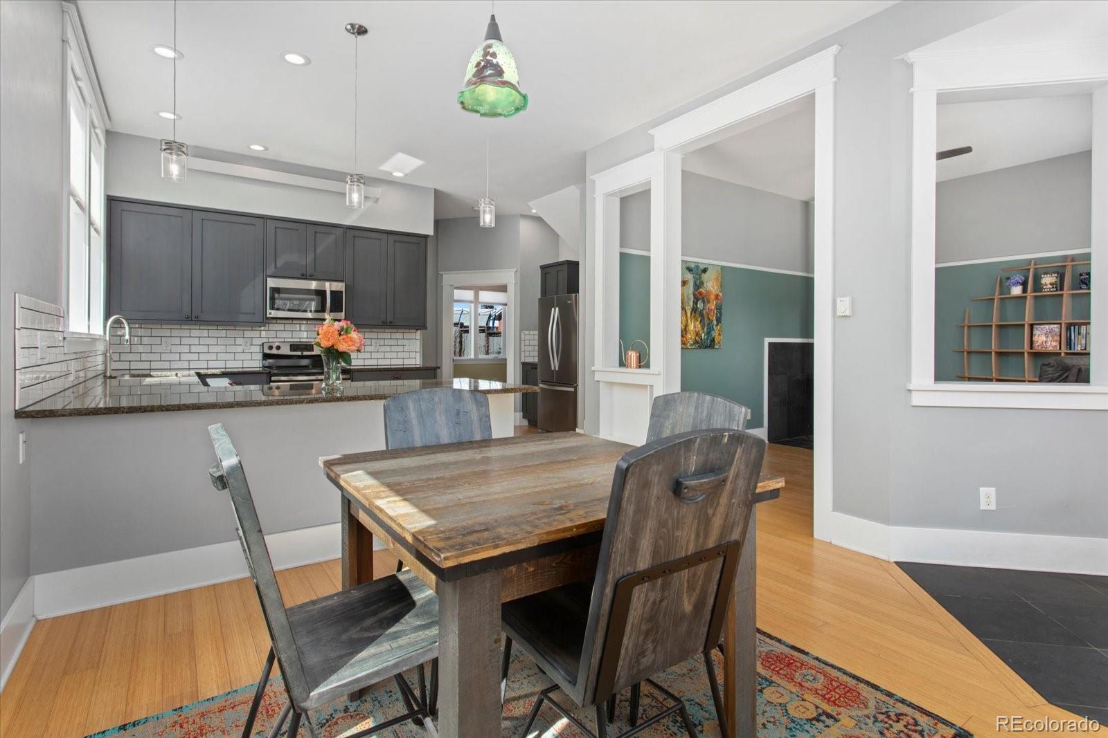 1208 E Street Salida, CO 81201 - Photo 8 of 50 a dining room with kitchen island a table and chairs