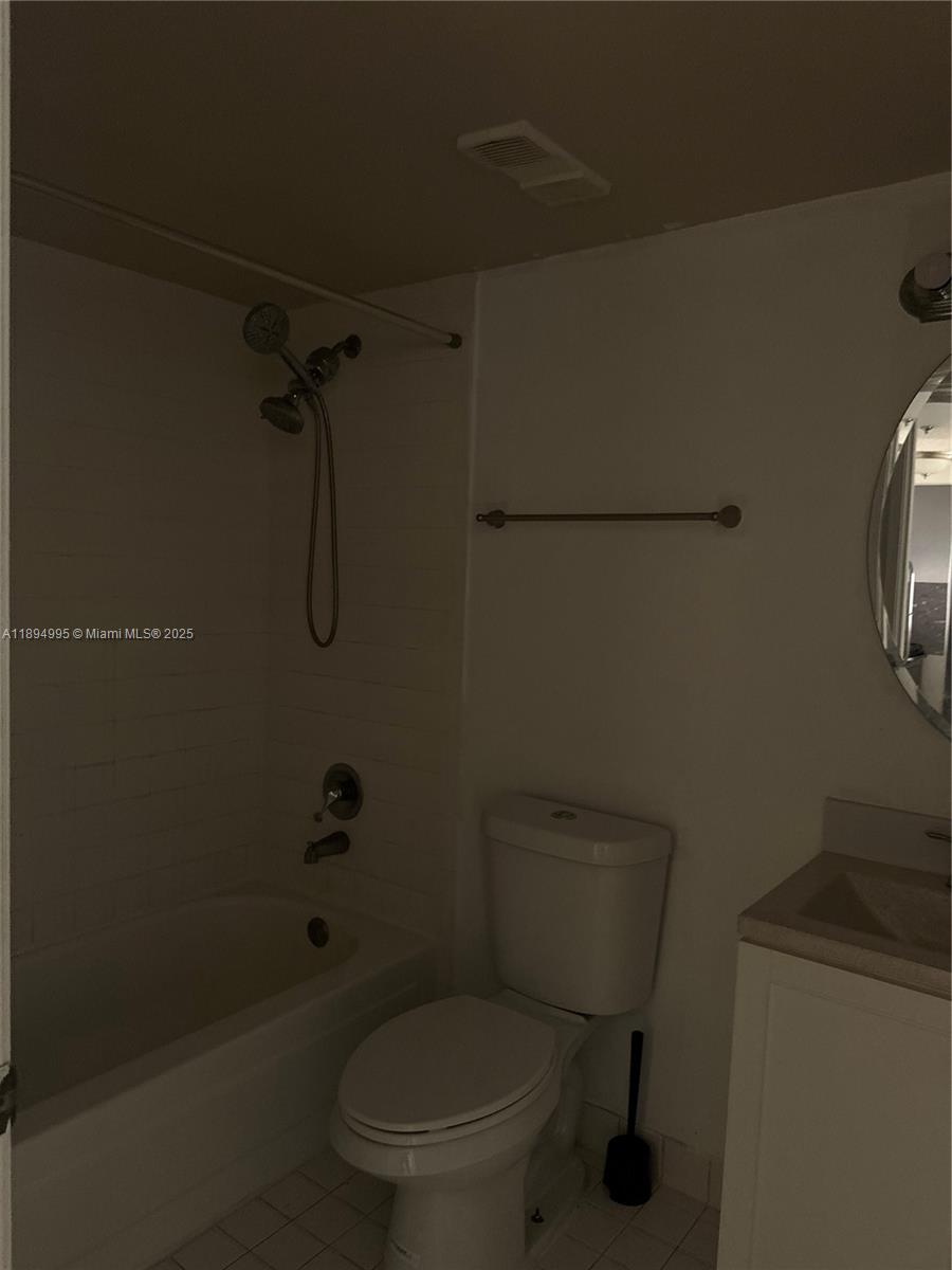 850 North Miami Avenue, Unit 810 Miami, FL 33136 - Photo 12 of 19 a white toilet sitting next to a bath tub