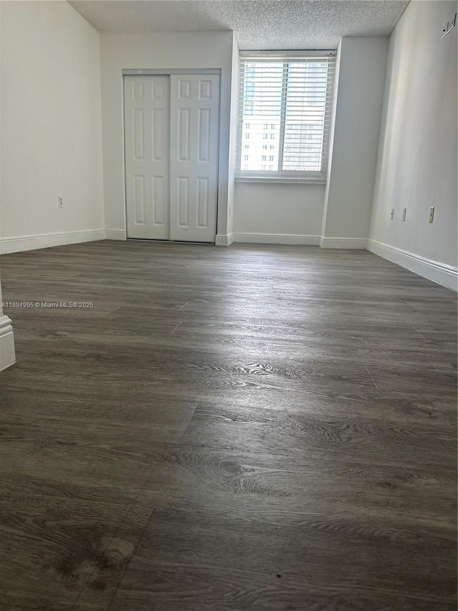 850 North Miami Avenue, Unit 810 Miami, FL 33136 - Photo 13 of 19 wooden floor in an empty room with a window