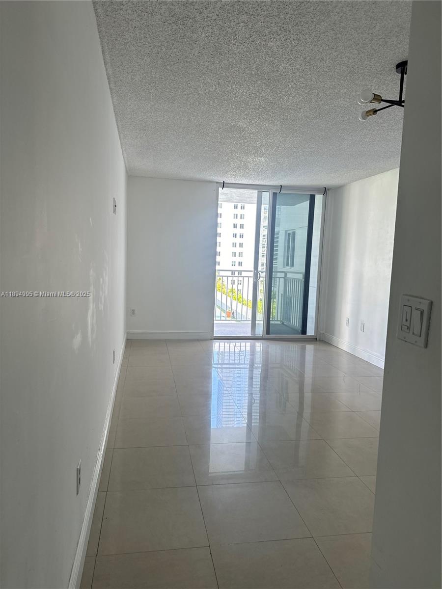 850 North Miami Avenue, Unit 810 Miami, FL 33136 - Photo 7 of 19 wooden floor in an empty room with a window