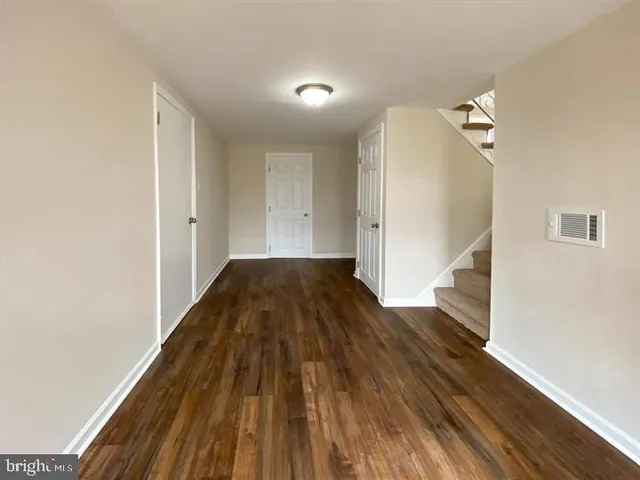 a view of a hallway view with wooden floor and staircase