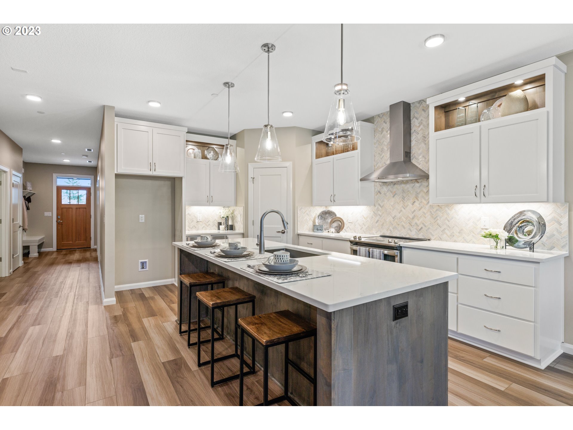 2034 South Royal Court Ridgefield, WA 98642 - Photo 4 of 48 a kitchen with a sink a center island stainless steel appliances and cabinets