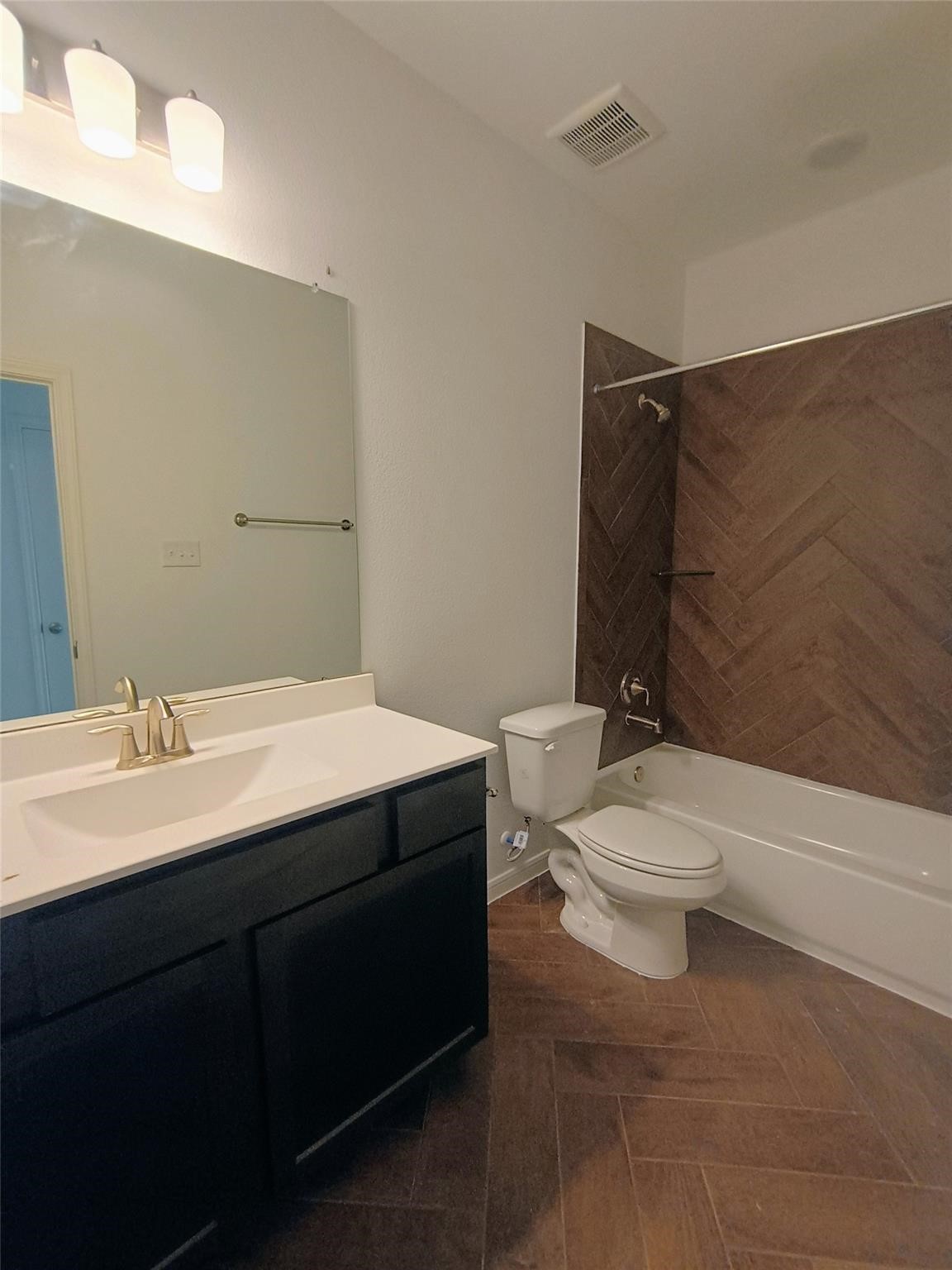 15924 Cy Young Court Splendora, TX 77372 - Photo 20 of 29 a bathroom with a toilet a sink and bathtub