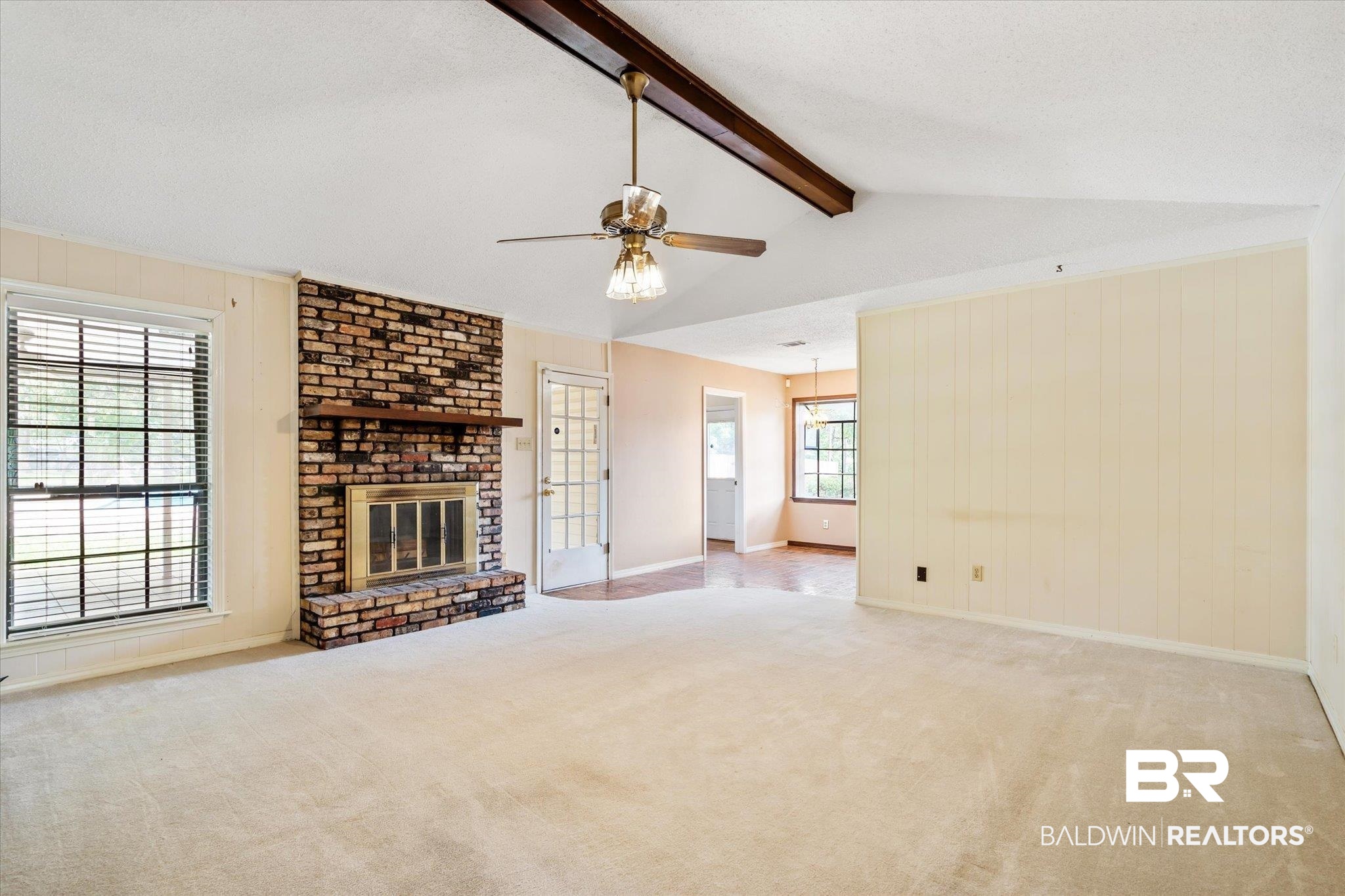 9623 Sunview Drive Semmes, AL 36575 - Photo 14 of 30 Unfurnished living room with a fireplace, a textured ceiling, ceiling fan, lofted ceiling with beams, and light colored carpet