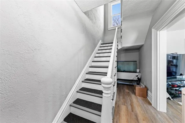 a view of entryway with wooden floor and stairs