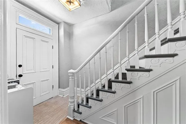 a view of entryway and hall with wooden floor