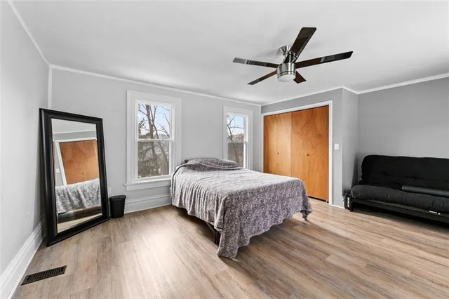 a bedroom with a bed a couch and a window