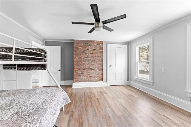 a view of empty room with wooden floor and window