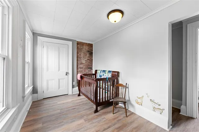 a view of a room with wooden floor and windows