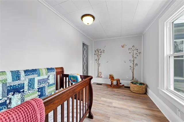a view of a room with lots of furniture and wooden floor