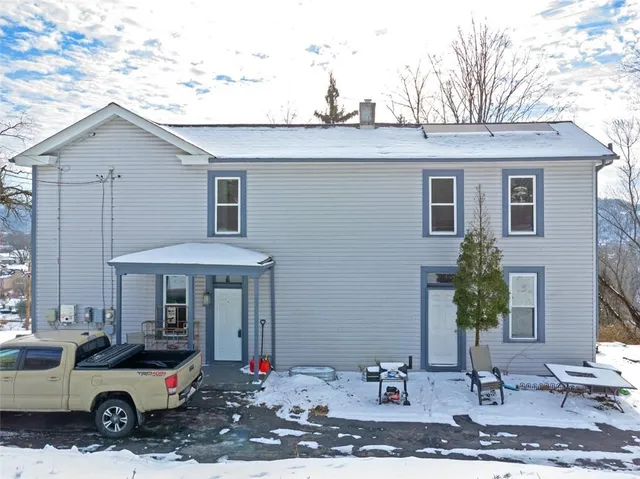 a car parked in front of white house