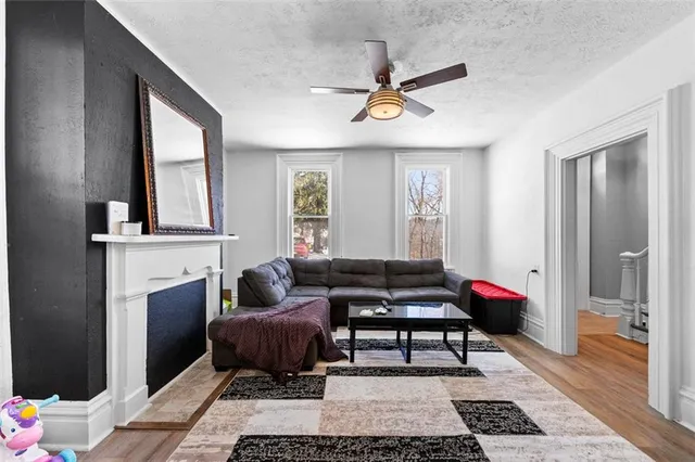 a living room with furniture and a fireplace
