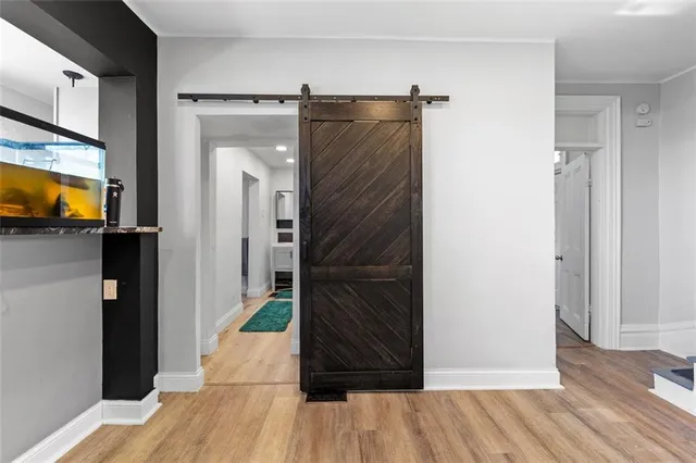 a view of hallway with wooden floor and stairs