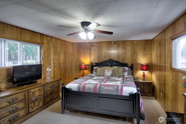 a bedroom with a bed and a flat screen tv