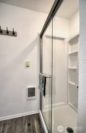 a bathroom with a shower and a glass door