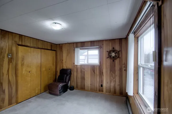a view of a hallway with closet and door