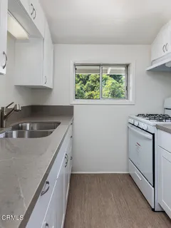 a kitchen with a sink stove and cabinets