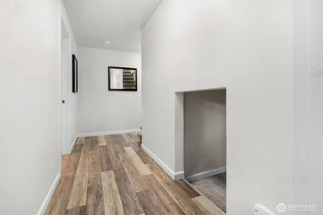 a spacious bedroom with a bed and a painting on the wall