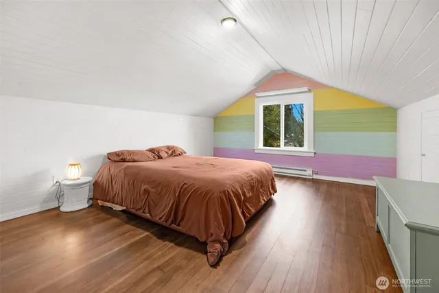 a room with gym equipment and wooden floor