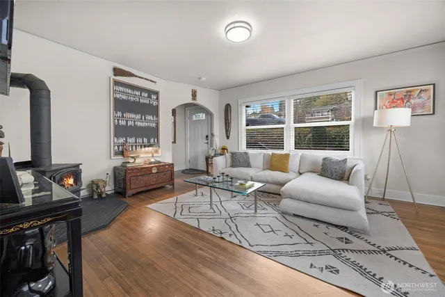 a living room with furniture a rug and a window