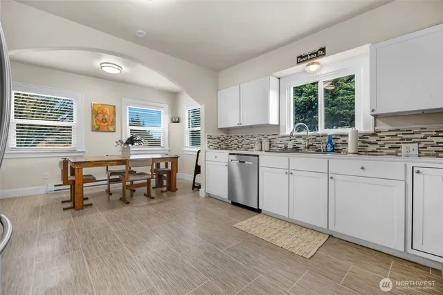 a kitchen with a sink cabinets and window