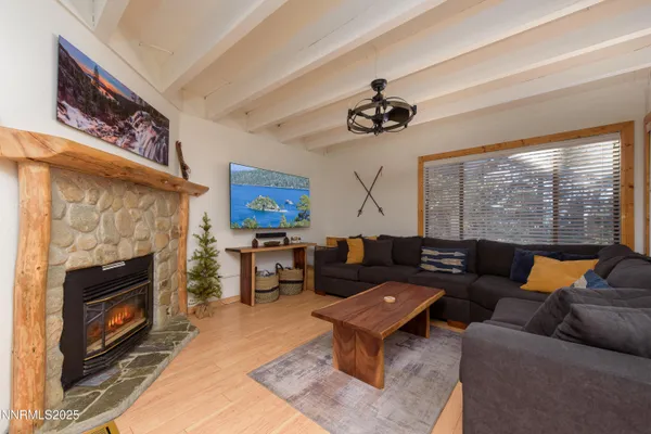 a living room with furniture a fireplace and a large window