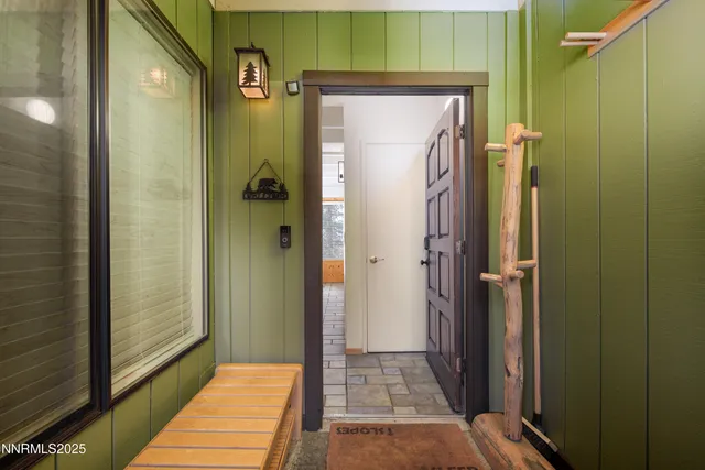 a bedroom with a bed a mirror and a potted plant