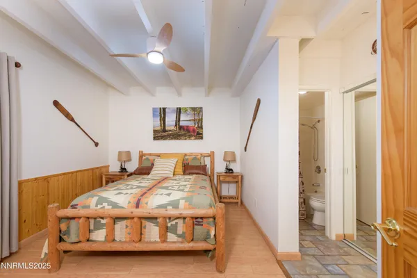 a bed sitting in a bedroom next to a window