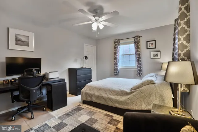 a bedroom with a bed and a desk